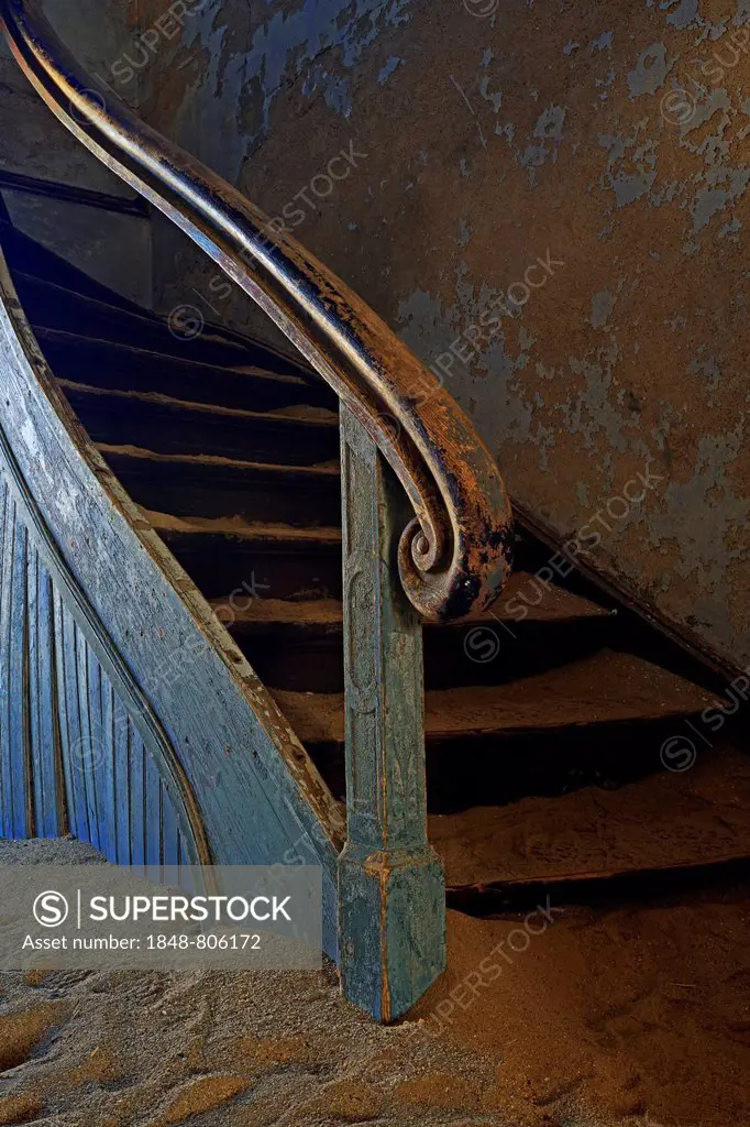 Staircase in a house that has been filled by desert sand, in the former diamond city of Kolmanskuppe, now a ghost town, Kolmannskuppe, Karas Region, N...