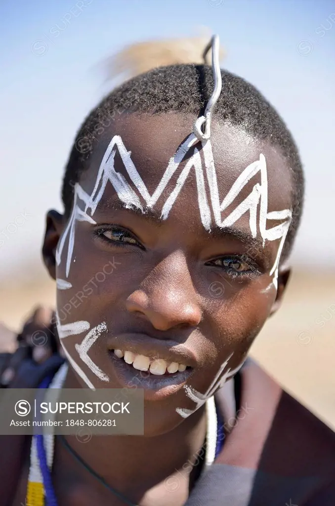 Young Maasai warrior with a painted face, Ngorongoro Conservation Area, Ndema, Tanzania