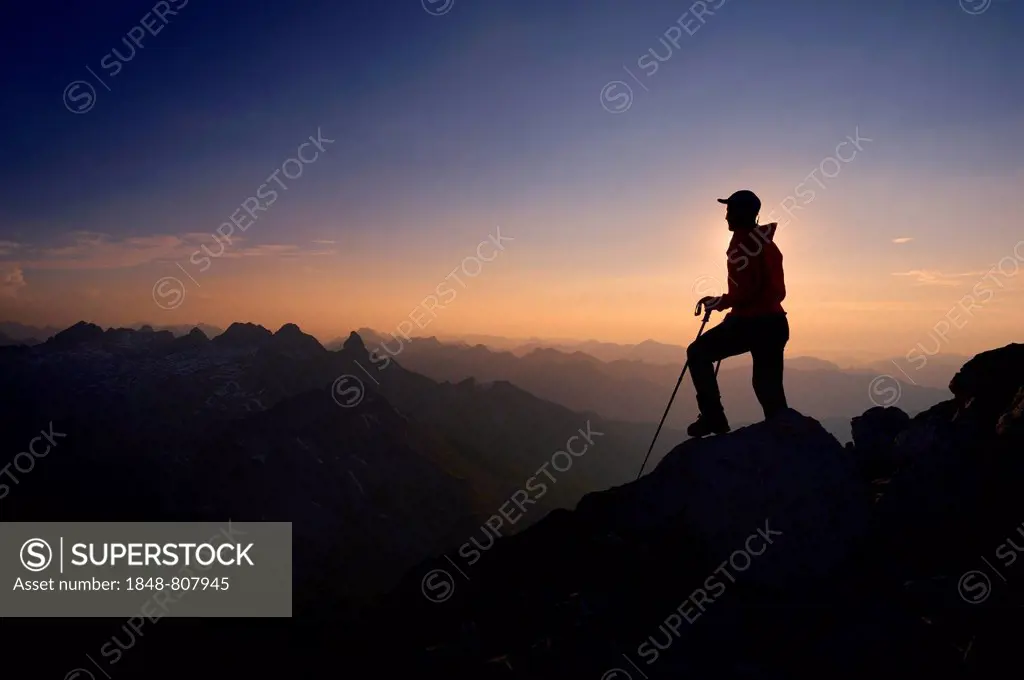 Mountaineer on Großer Krottenkopf Mountain at dusk, Allgäuer Alpen, Tyrol, Austria