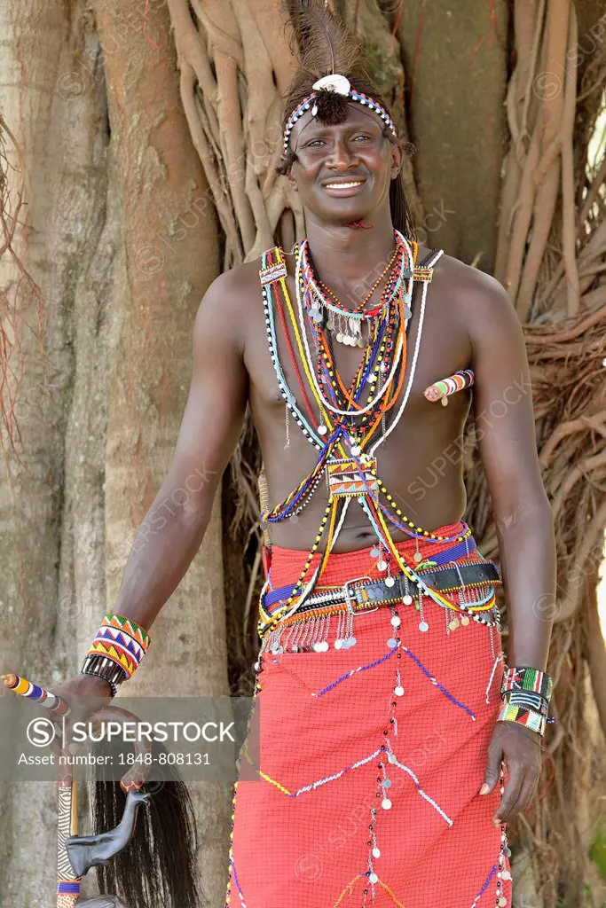 Maasai warrior wearing traditional dress, near Enkutoto, Masai Mara, Rift Valley Province, Kenya
