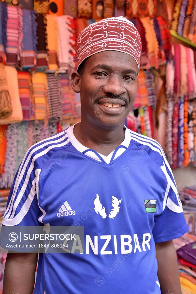 Clothing merchant wearing a football jersey of the Zanzibar Heroes, Stone Town, Zanzibar City, Zanzibar, Tanzania