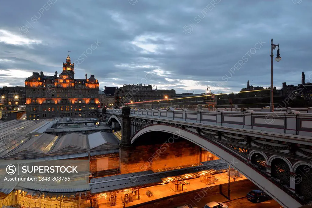Views of the old town illuminated in the evening with the tower of the Balmoral Hotel, Waverley Station, Calton Hill, North Bridge, Edinburgh, Scotlan...