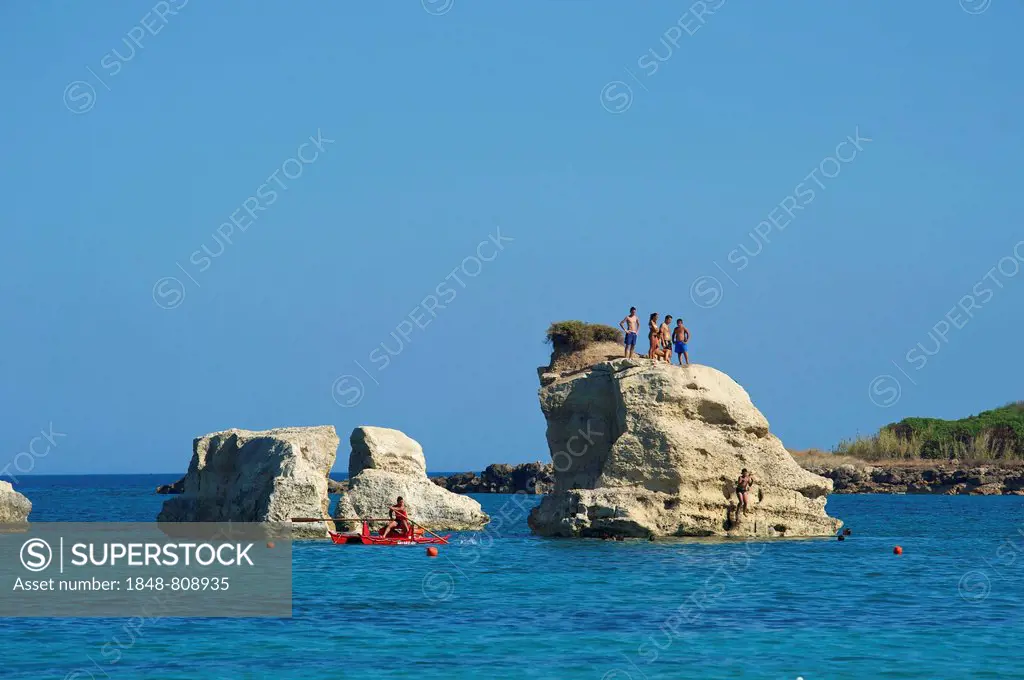 Tourists on a rock formation, near Noto, Ragusa Province, Sicily, Italy