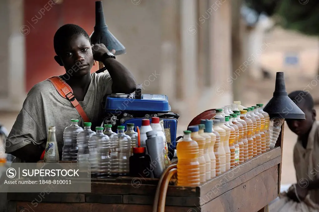 Seller of motorcycle petrol, Tourou, Far North, Cameroon