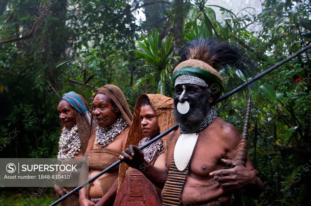 Tribal chief and three women wearing traditional dresses, Highlands Region, Papua New Guinea