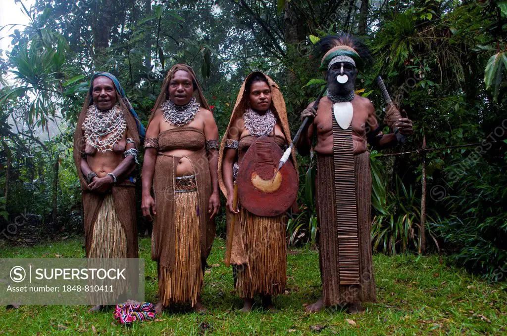 Tribal chief and three women wearing traditional dresses, Highlands Region, Papua New Guinea