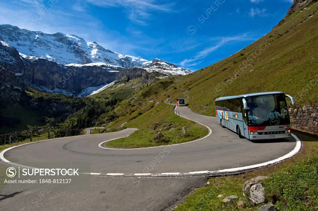 Coach in a hairpin curve, mountain road to the Klausen Pass in front of the Glarus Alps, Urnerboden, Canton of Uri, Switzerland