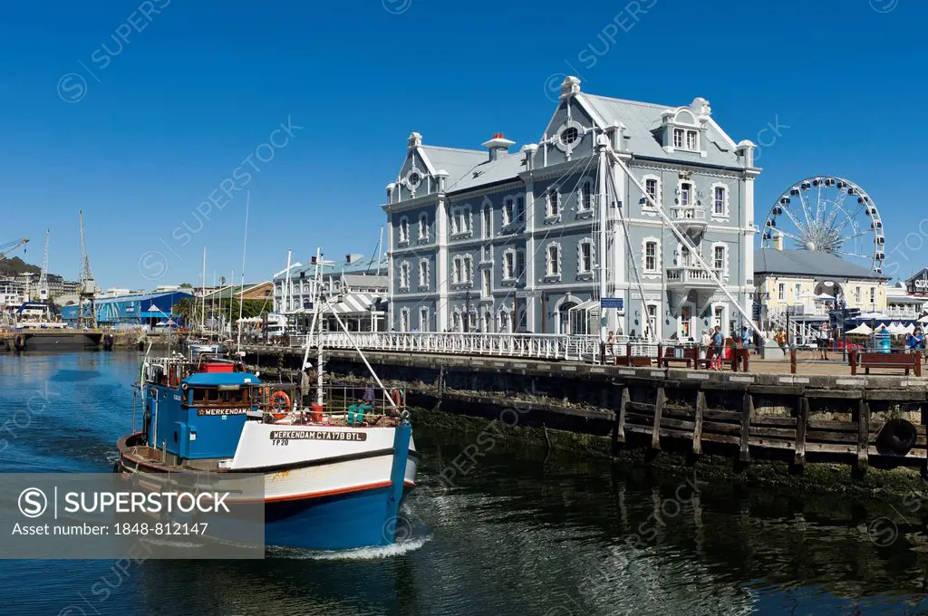 Fishing cutter in front of the African Trading Port building, Victoria and Alfred Waterfront, Cape Town, Western Cape, South Africa