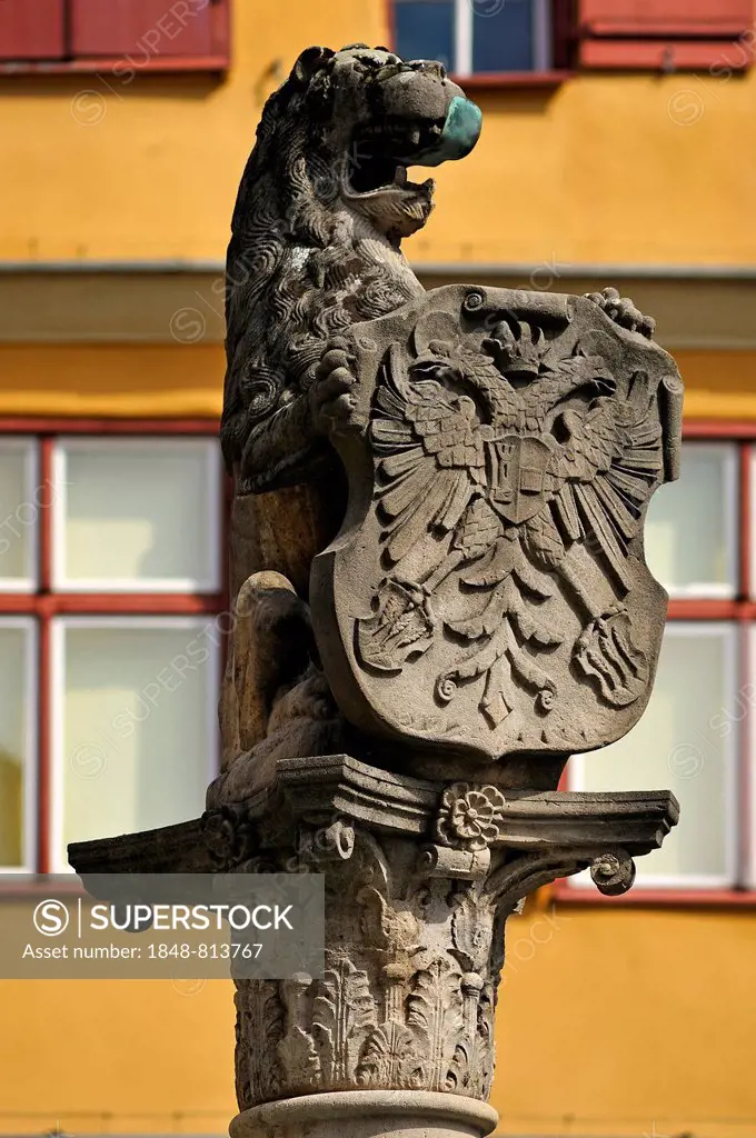 Lion sculpture holding a shield with the double-headed eagle at Loewenbrunnen, Lion's fountain, Dinkelsbühl, Middle Franconia, Bavaria, Germany
