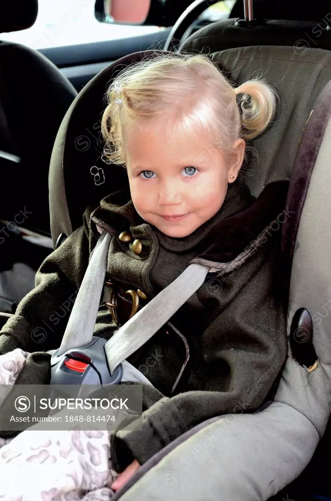 Girl in a car safety seat in a car, Scania, Sweden