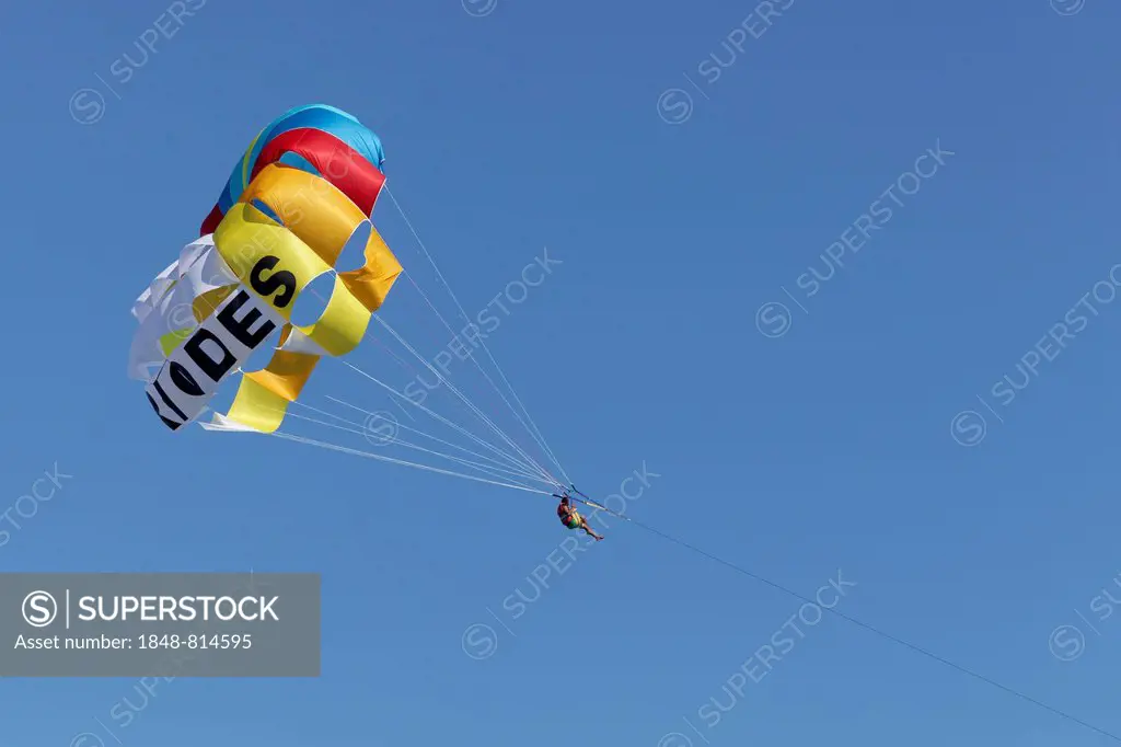 Parasailing, man hanging from a paraglider in the air, new town, Rhodes, Rhodos Island, Dodecanese, Greece