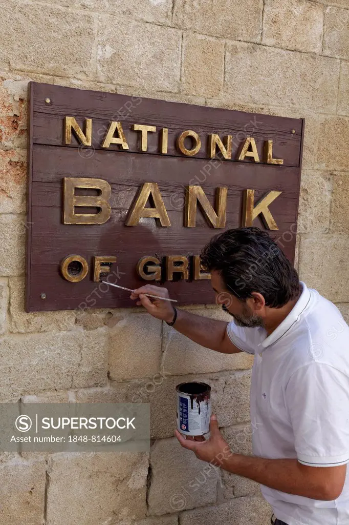 Sign National Bank of Greece, man painting the sign, new town, Rhodes, Rhodos Island, Dodecanese, Greece