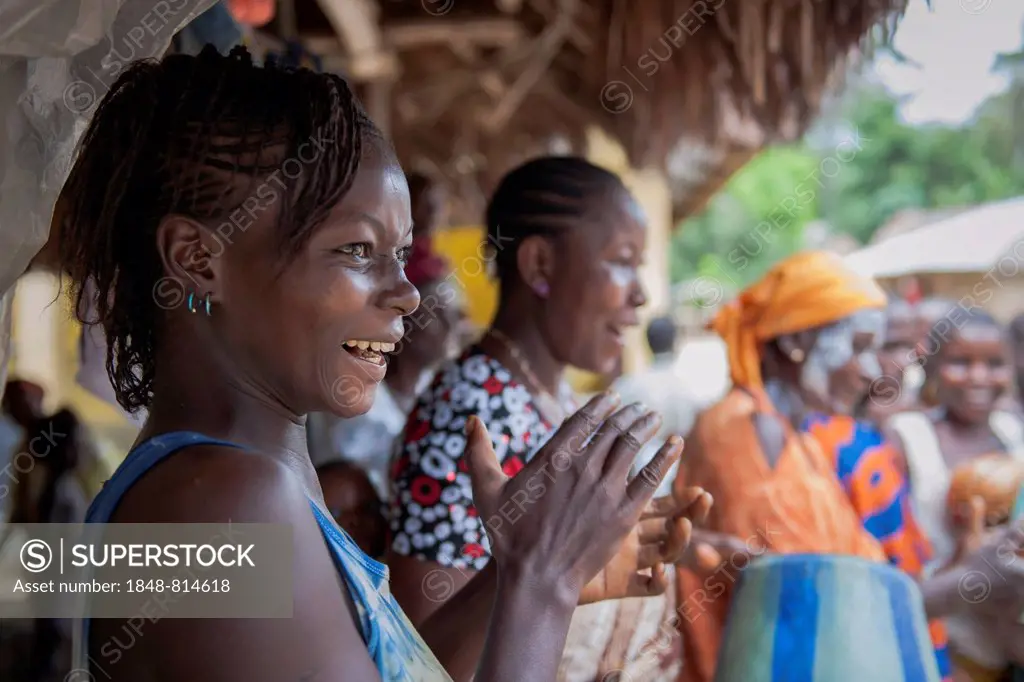Villagers celebrating a festival with traditional dance and music, Tiwai Island, Southern Province, Sierra Leone