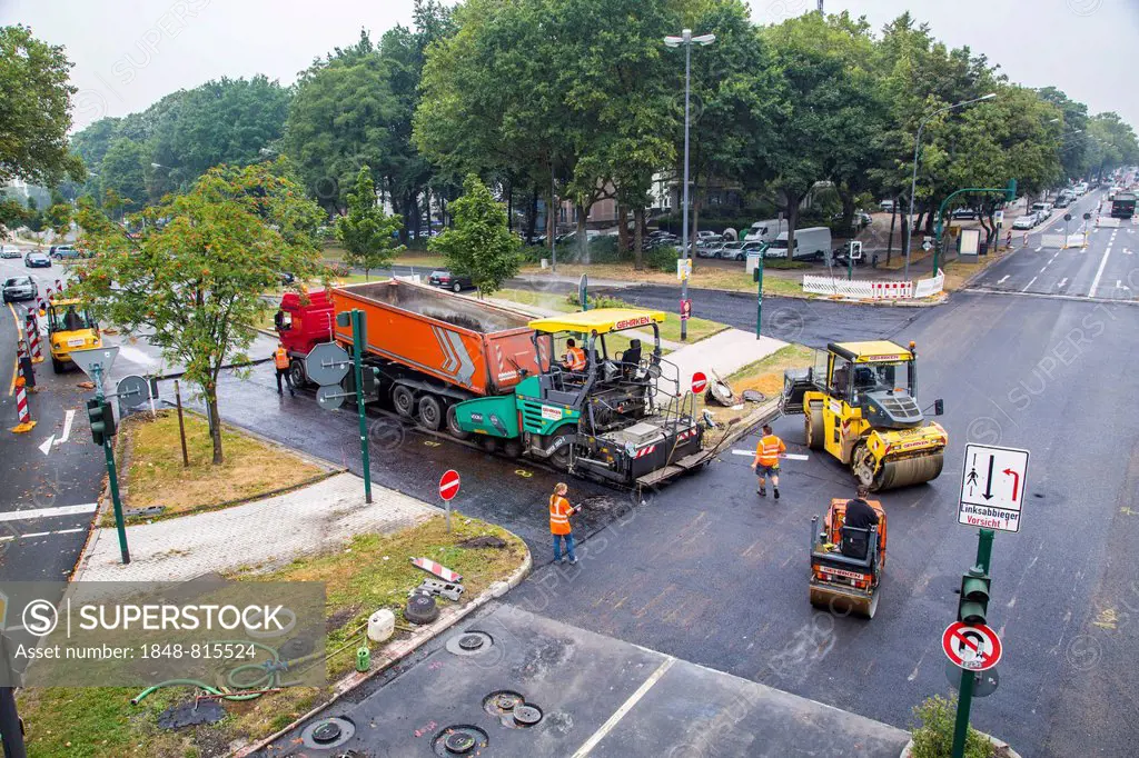 Rolling machines and an asphalt spreader during asphalt work on a large urban road construction site, Essen, North Rhine-Westphalia, Germany