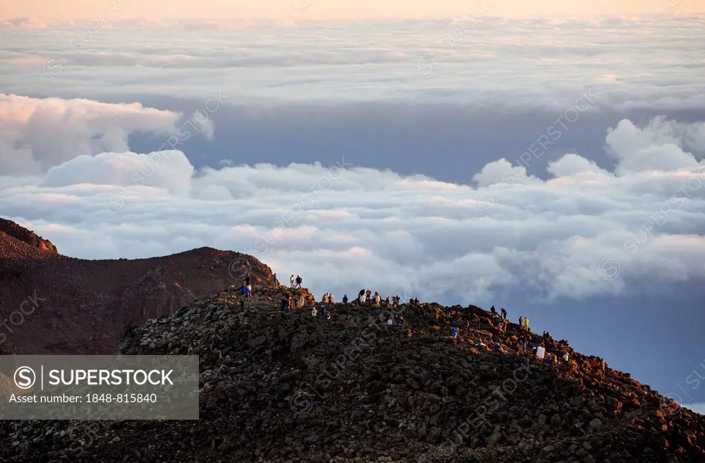 Tourists on the summit of the Haleakala volcano at sunrise, Haleakala National Park, Maui, Hawaii, USA