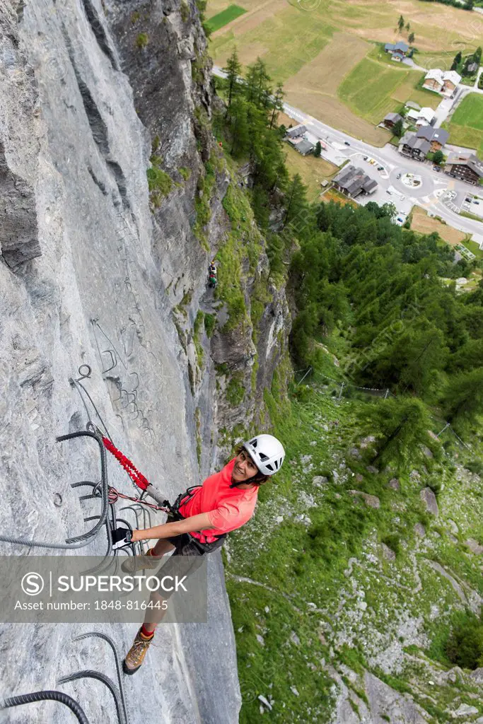 Female climber on the fixed rope route Via ferrata d'Evolene Region, Evolène, Canton of Valais, Switzerland