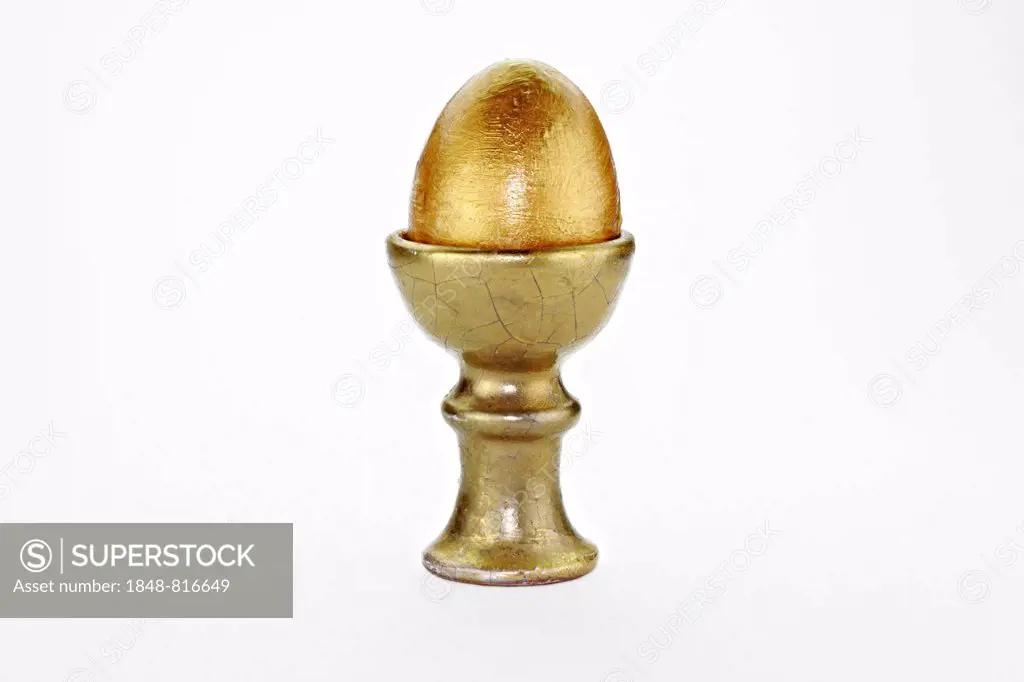 Golden egg in an egg cup, Germany