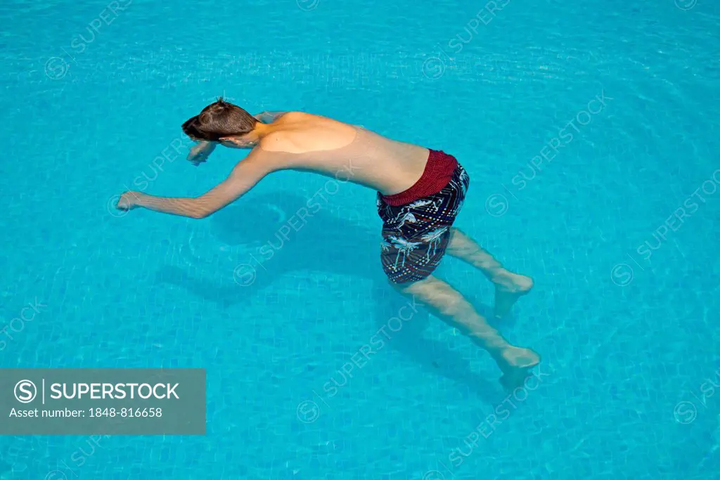 Motionless boy in a swimming pool