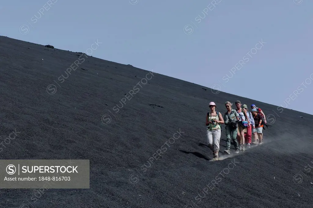 Hikers in the ash field of the Pico do Fogo volcano, Fogo National Park, Fogo island, Cape Verde