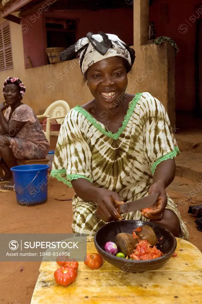 Woman preparing a traditional tomato dish, Kuluedor, Ghana
