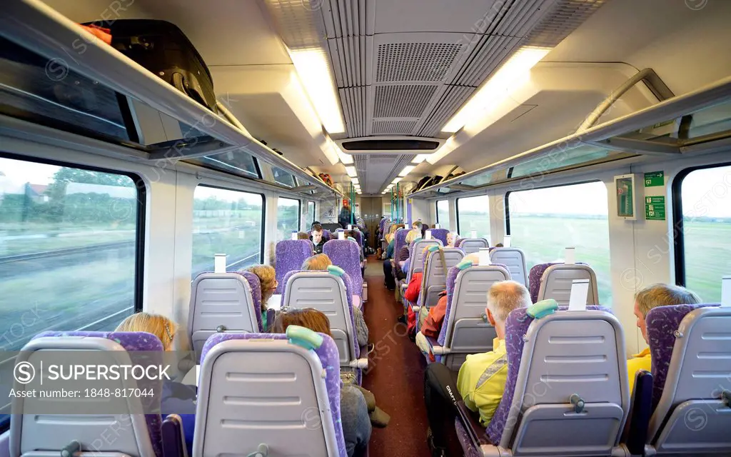 Interior of an open-plan carriage with travellers in the Pennine Express of the East Coast Railway, England, United Kingdom
