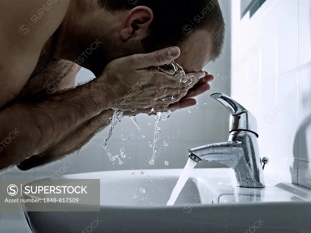 Man washing his face with both hands