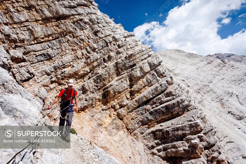 Climber on the descent from Mt Monte Cristallo, Via Ferrata Ivano Dibona, Dolomites, Belluno, Italy