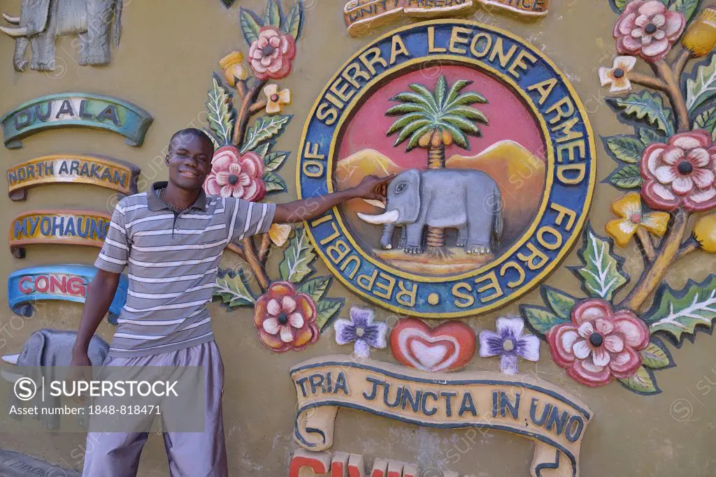 Tour guide standing at the Sierra Leone Peace and Cultural Monument, Freetown, Sierra Leone
