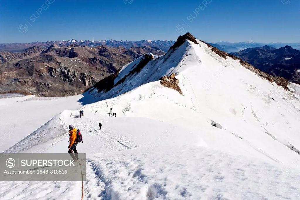 Mountain climbers on the summit ridge of Mount Cevedale in front of Zufallspitze Mountain, Alto Adige, Italy