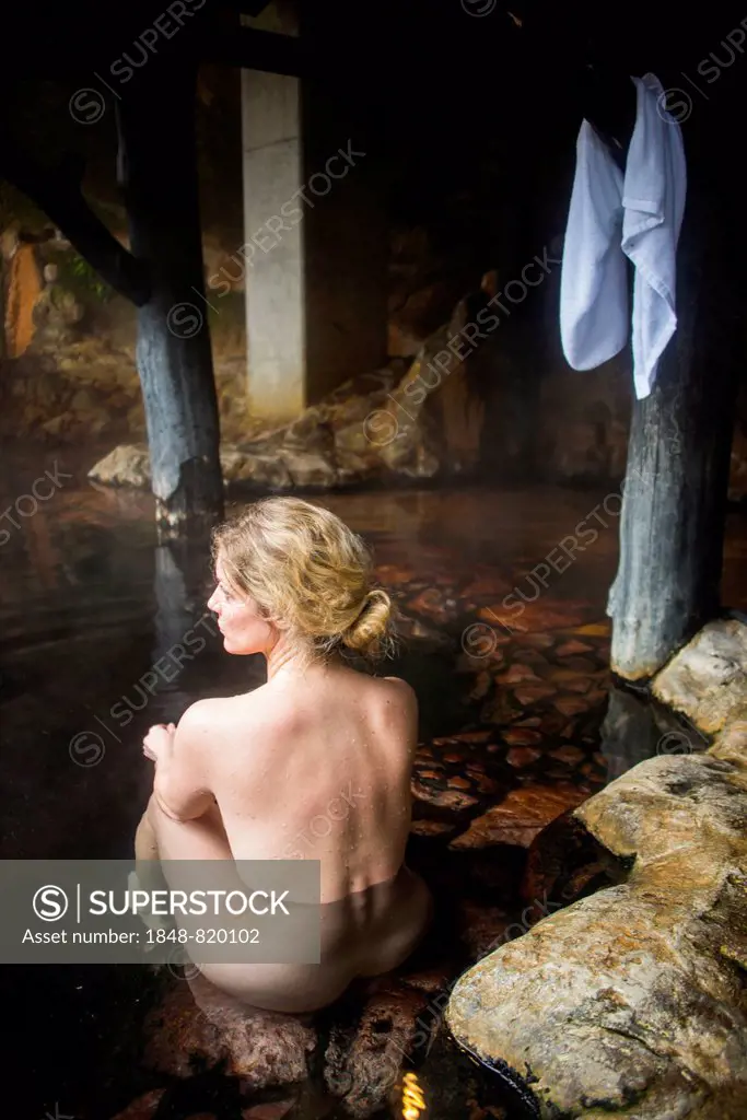 Woman enyoing the hot waters of the Kurokawa onsen, public spa, Kyushu, Japan
