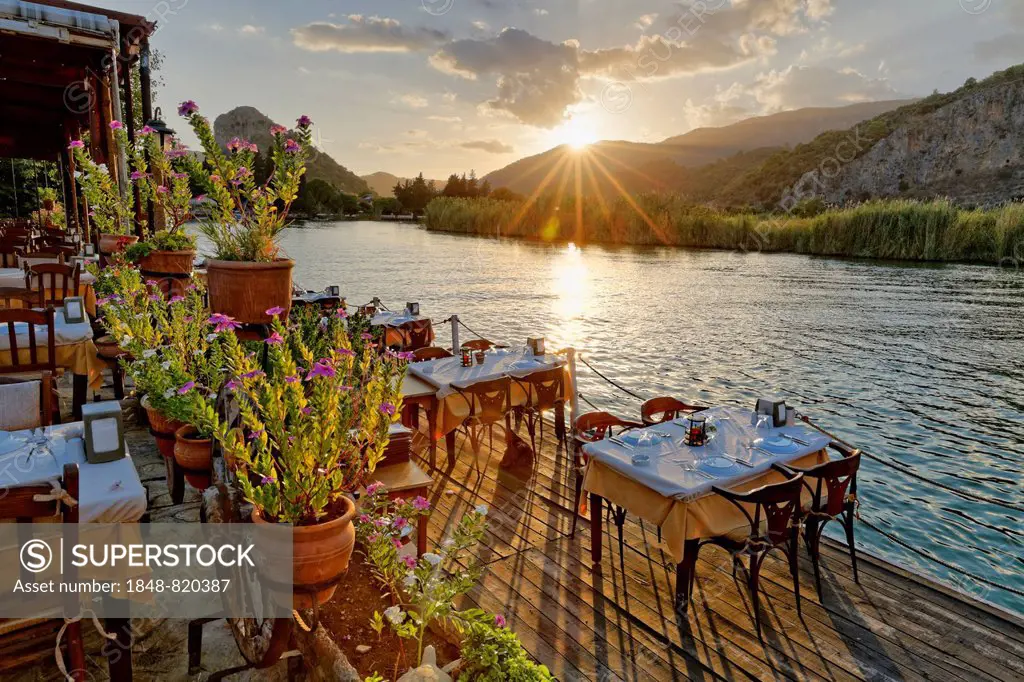 Sunset, set tables in a restaurant on the Dalyan River, Dalyan, Mugla Province, Turkish Riviera or Turquoise Coast, Aegean, Turkey