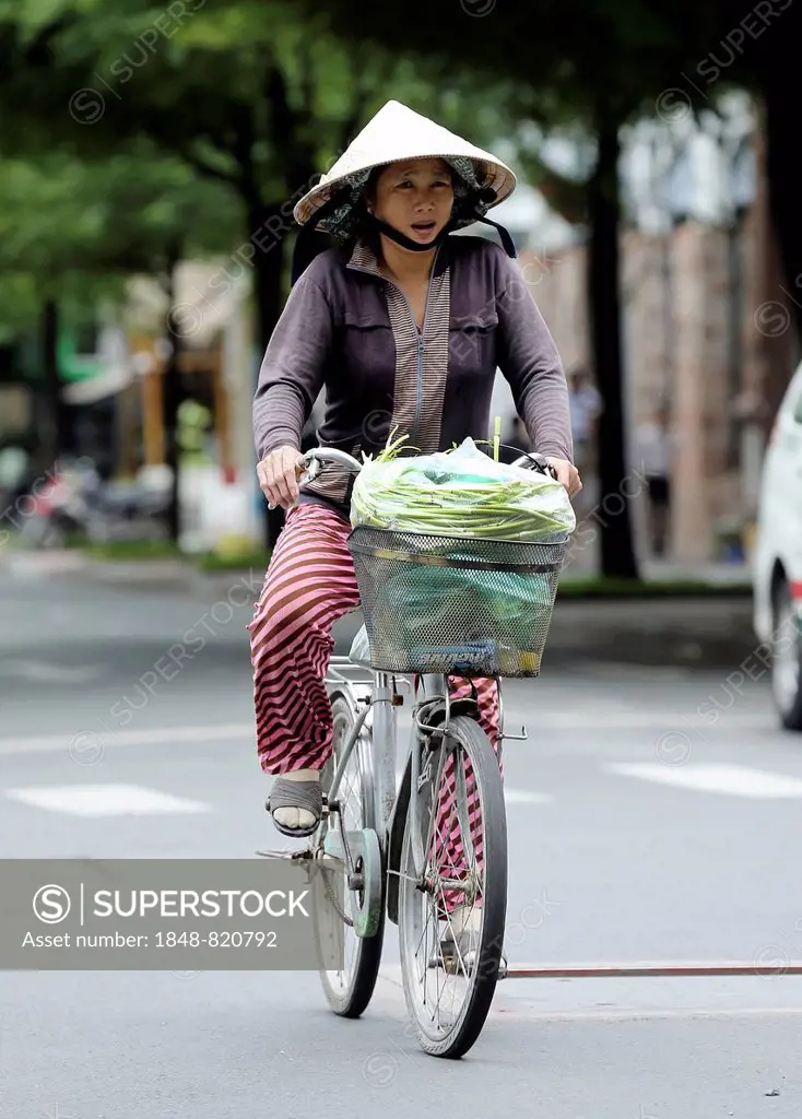 Woman on bicycle, Ho Chi Minh City, Vietnam