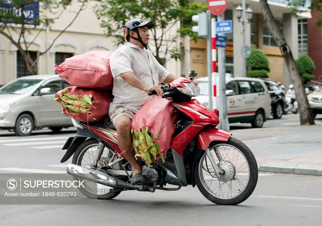 Man on a packed bike, Ho Chi Minh City, Vietnam