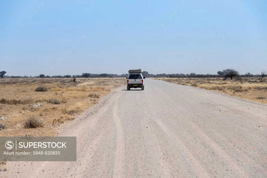 Car on dirt road, Etosha National Park, Namibia