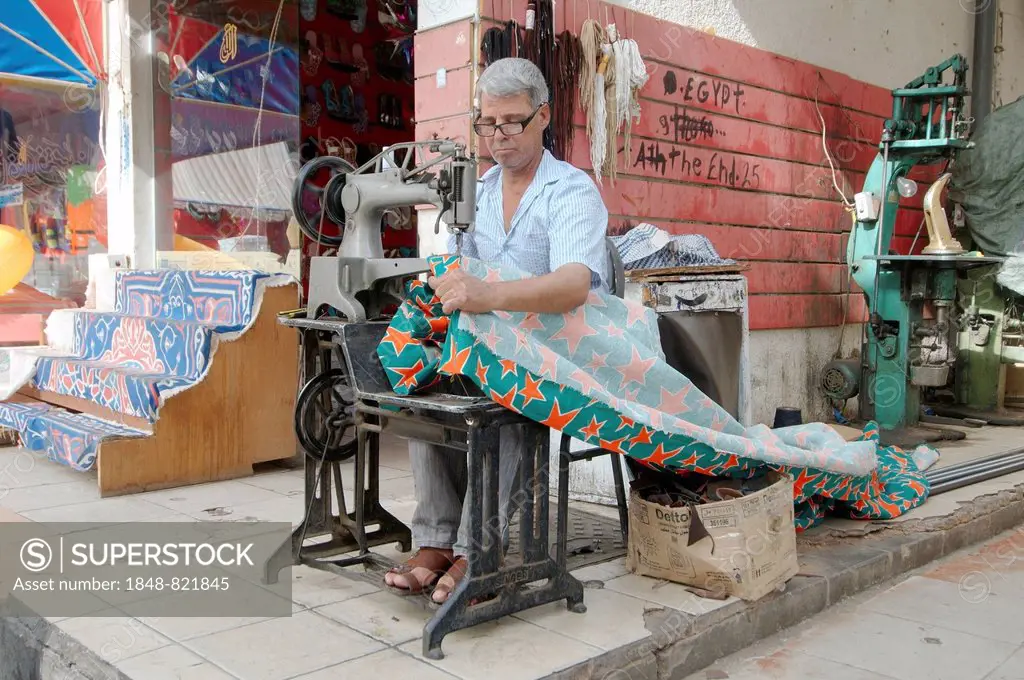 Tailor sewing a curtain, Old Market, Sharm el-Sheikh, Sinai Peninsula, Egypt