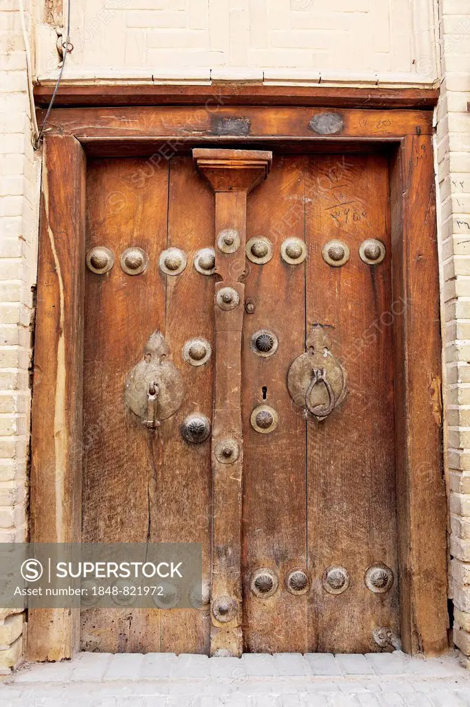Old wooden door with different door knockers for male and female visitors, historic centre, Yazd, Yazd Province, Persia, Iran