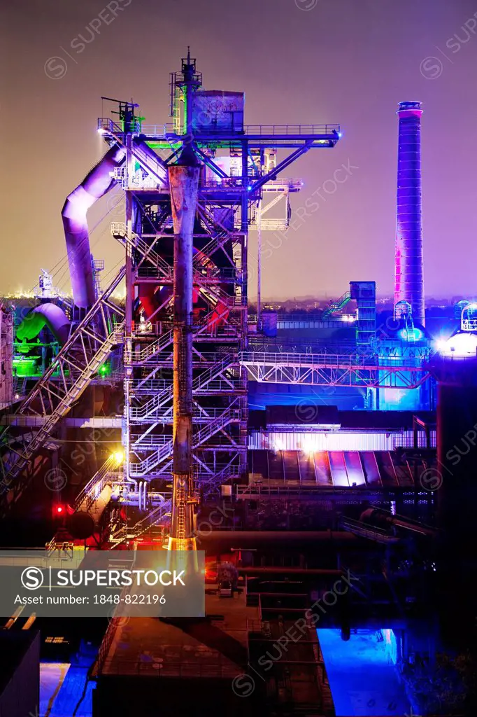 The disused steelworks in Landschaftspark Duisburg-Nord, public park on a former industrial site, illuminated at night with blast furnace No 2, Duisbu...