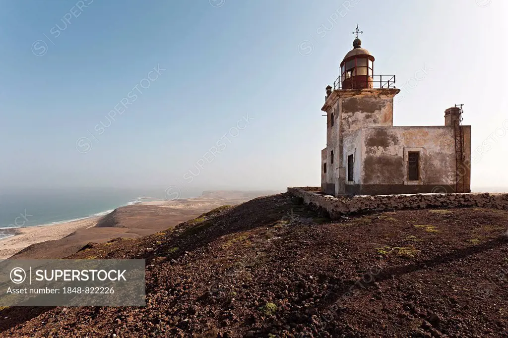 The abandoned lighthouse Farol de Morro Negro on the black mountain Morro Negro on the east coast of the island of Boa Vista, Cape Verde, Republic of ...