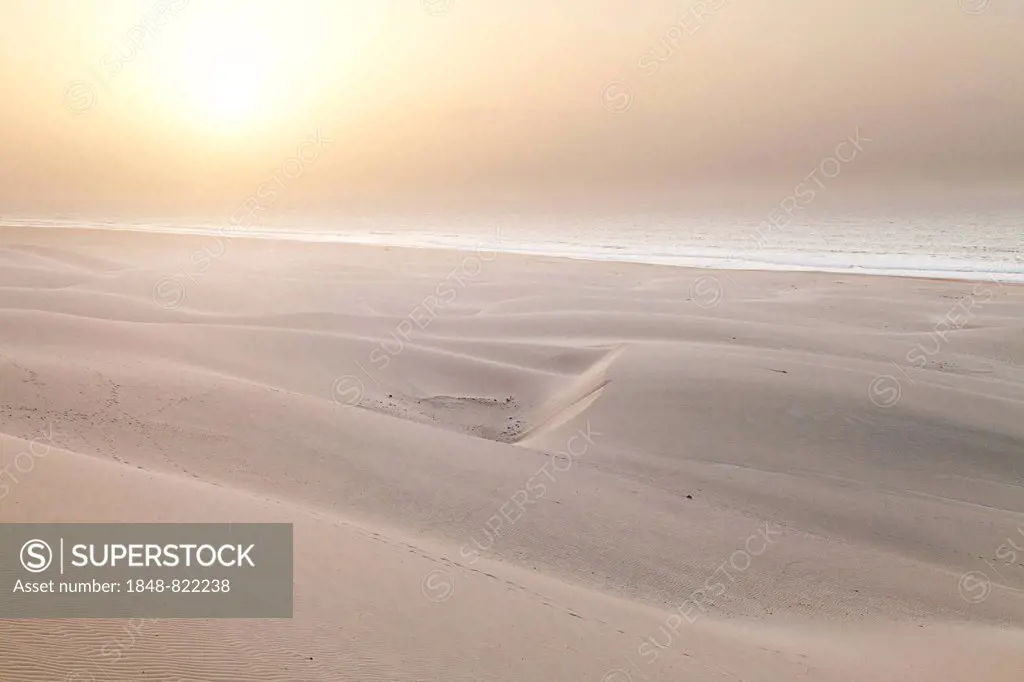 Sun in the mist of the sea above the sand dunes on Praia de Chaves Beach, on the west coast of the island of Boa Vista, Cape Verde, Republic of Cabo V...