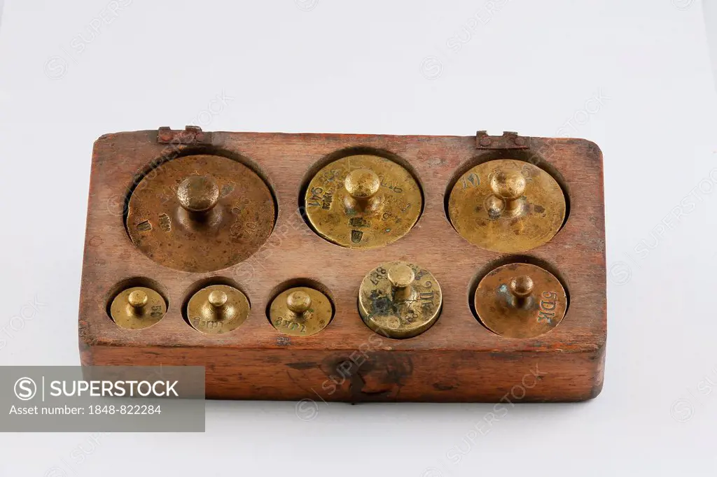 Old brass weights in a wooden box