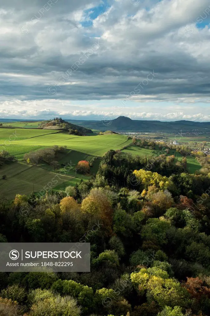 View from the fortress ruins of Hohenkrähen Castle over the Hegau landscape with Mägdeberg Mountain and Hohenhewen Mountain, Baden-Wuerttemberg, Germa...