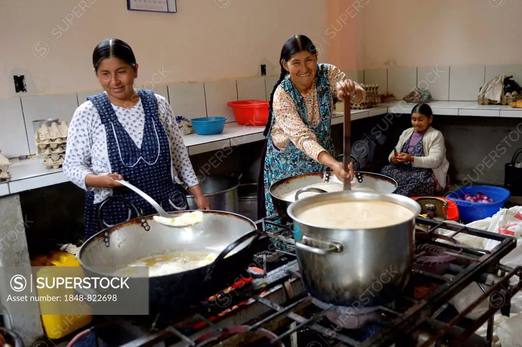 Cooks working in the kitchen of a boarding school, Carmen Pampa, Yungas, Department of La Paz, Bolivia