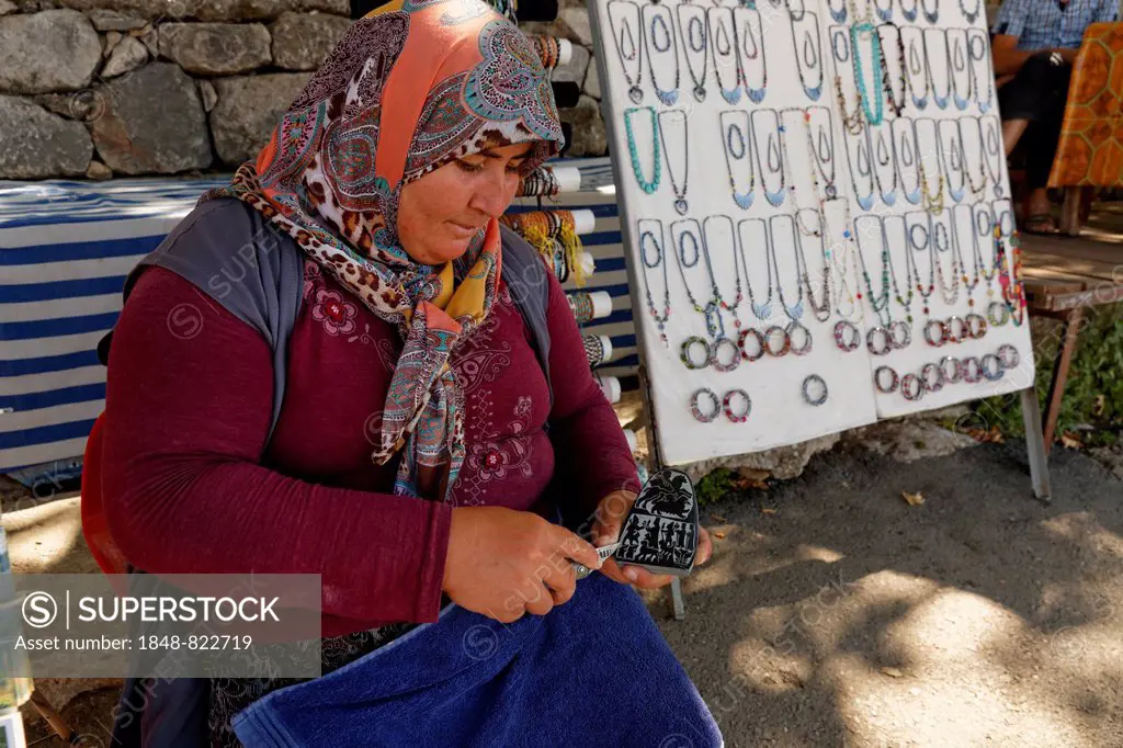 Woman carving a stone, ancient city of Tlos in the Xanthos Valley, Mugla Province, Lycia, Aegean, Turkey