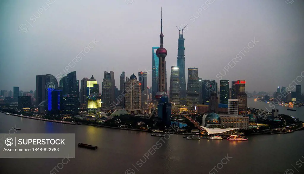 Skyline of the Financial District with the Oriental Pearl Tower and the Shanghai Tower, Pudong with the Huangpu River at dusk, Shanghai, China