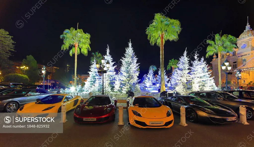 Four McLaren sports car in front of Christmas decoration with white fir trees on the square in front of the Casino de Monte-Carlo, Principality of Mon...
