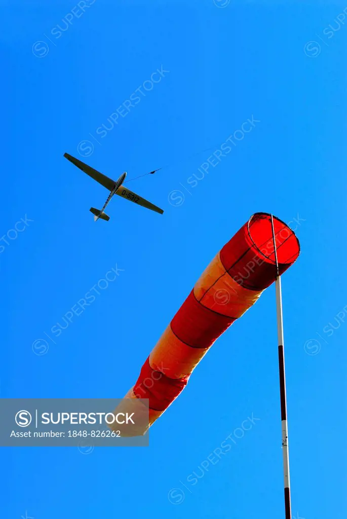 Glider at winch launching and wind sock as indicator for direction and strength of the wind, Hamburg, Germany