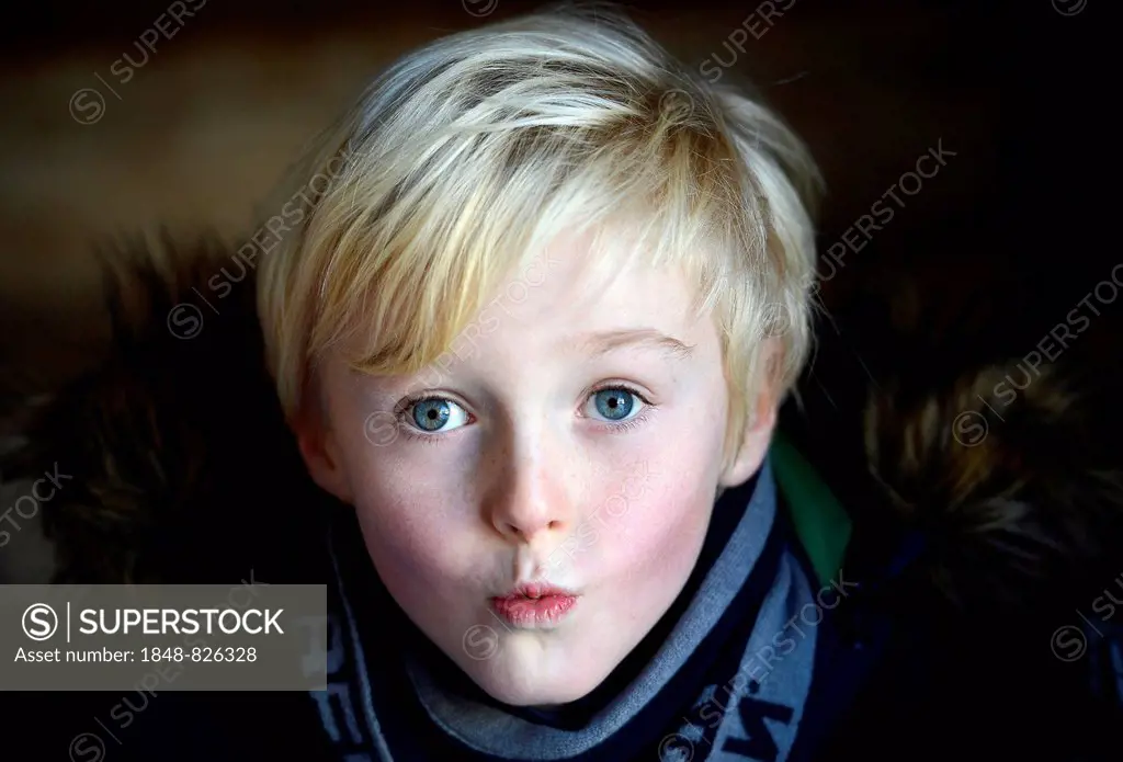 Boy, 7 years, makes a face, portrait
