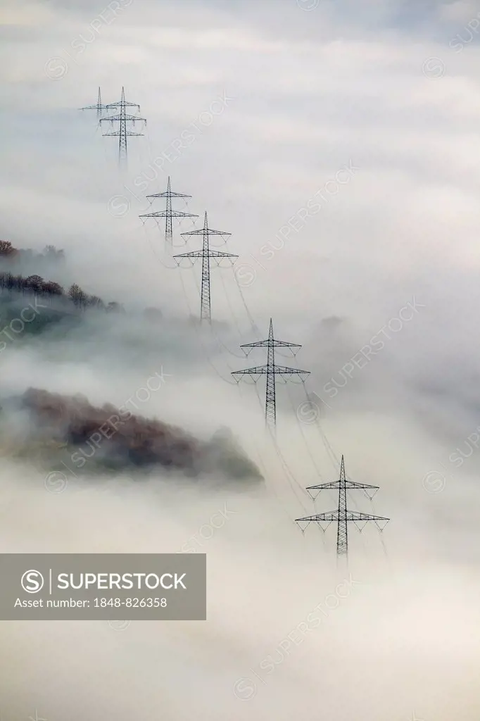 Pylons in the fog, at Bestwig, Sauerland, North Rhine-Westphalia, Germany