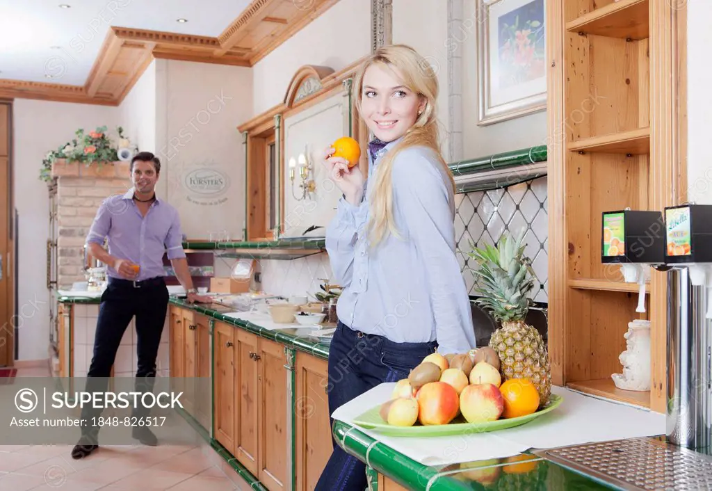 Man and woman standing at the breakfast buffet of a hotel