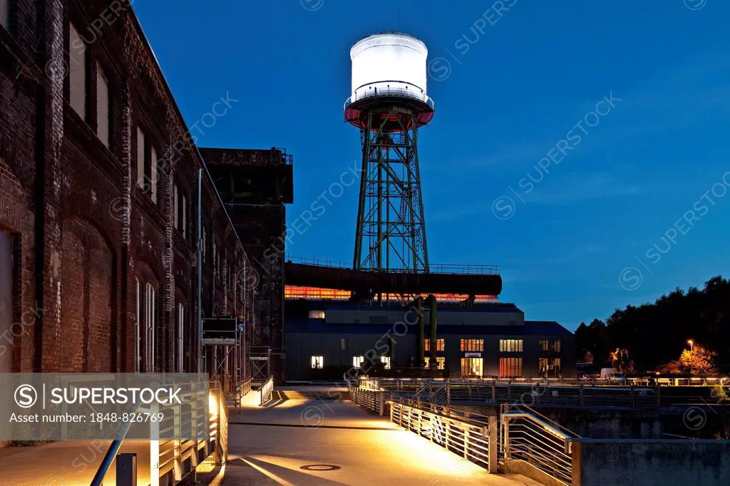 Jahrhunderthalle or Centennial Hall with a water tower at dusk, Bochum, North Rhine-Westphalia, Germany